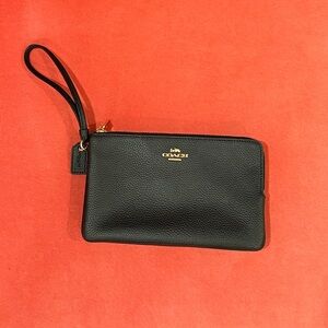 Coach Black Pebble Leather Wristlet with 8 credit card slots.